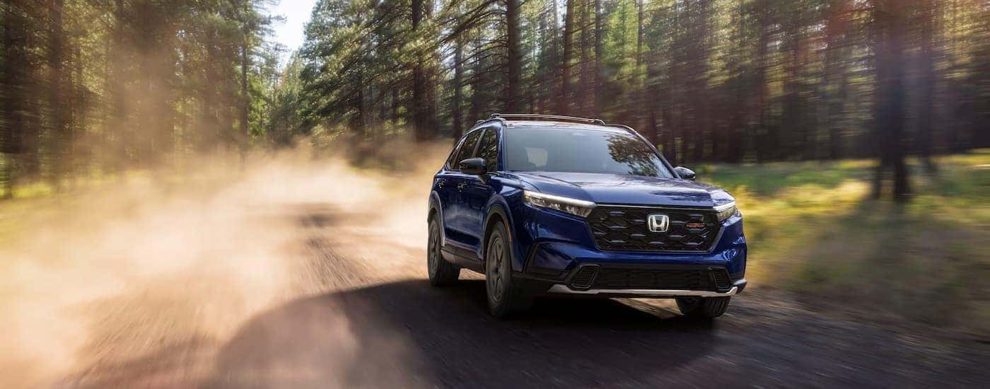 A blue 2026 Honda CR-V off-roading on a dirt road