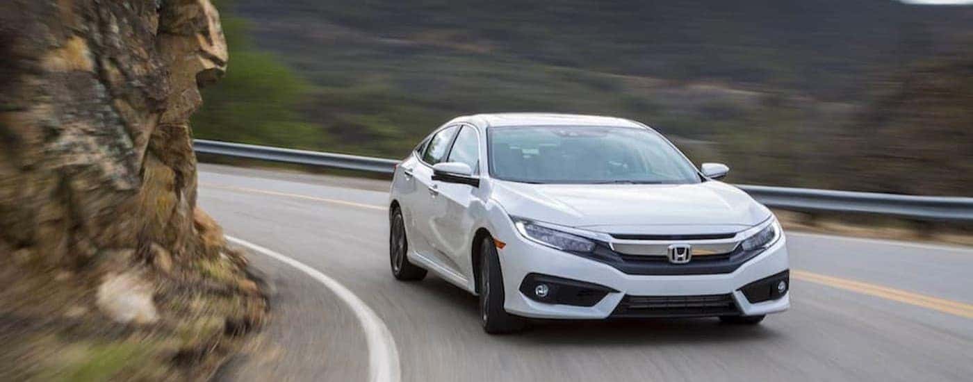 A used white 2016 Honda Civic for sale near Arlington driving.