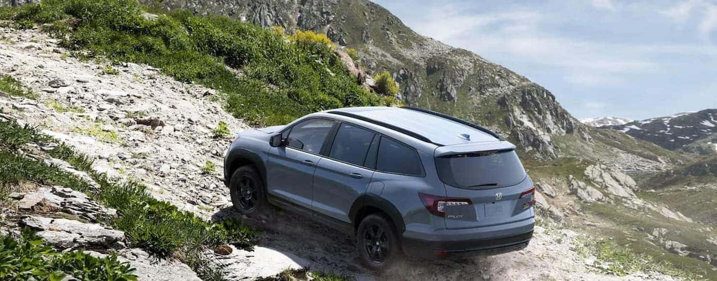 A gray 2022 Honda Pilot TrailSport off-roading.