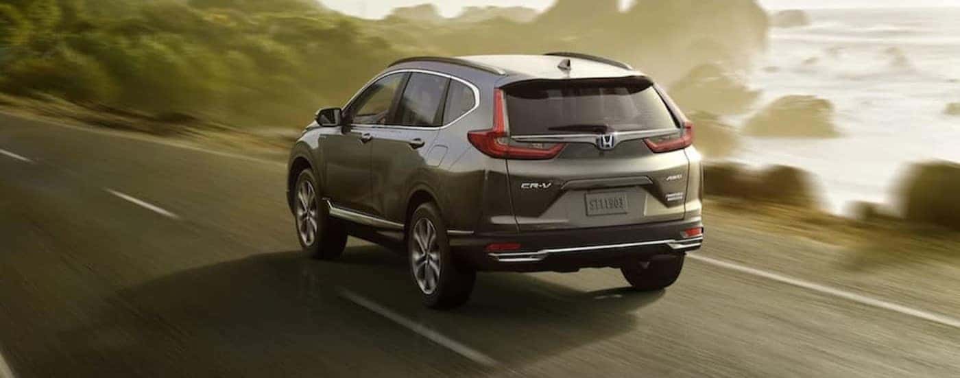 A silver 2021 Honda CR-V driving on a highway.