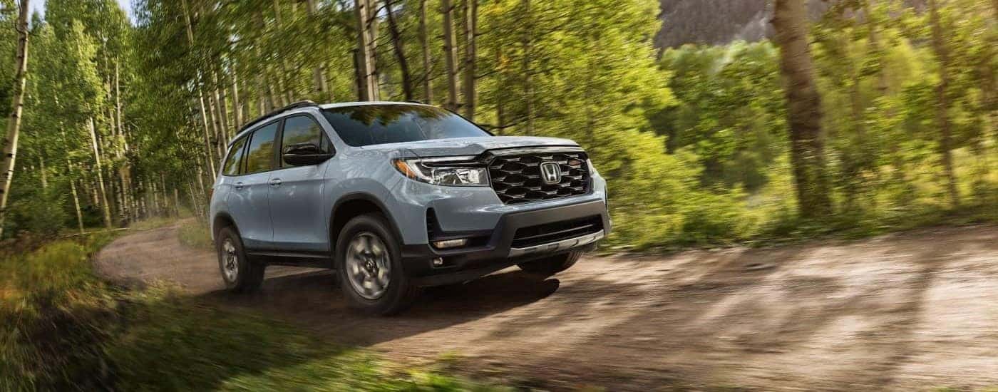 A gray used 2023 Honda Passport TrailSport off-roading for sale near Irving