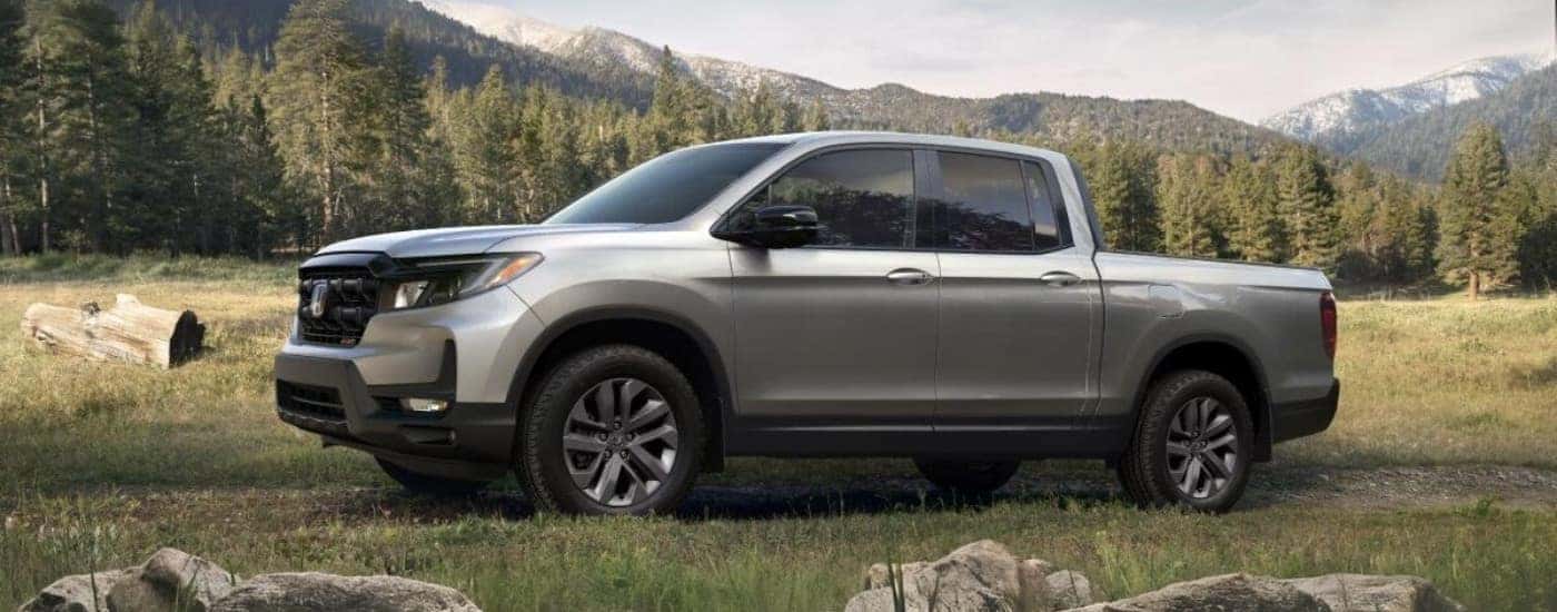 A gray 2025 Honda Ridgeline Sport parked on grass