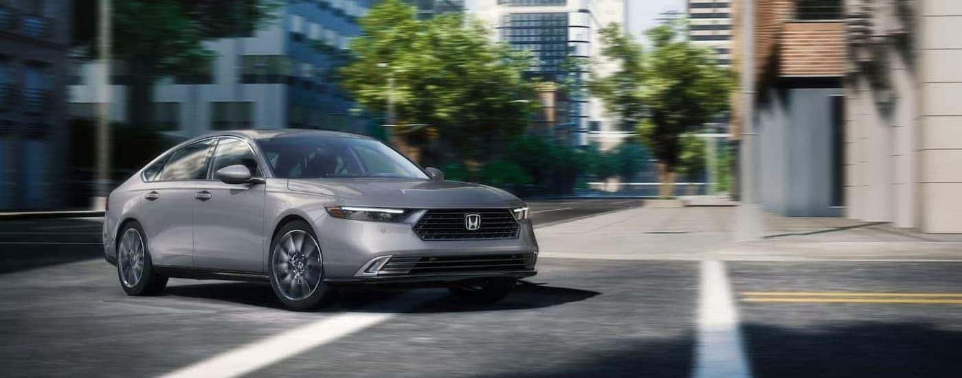 A gray 2025 Honda Accord driving in a city.