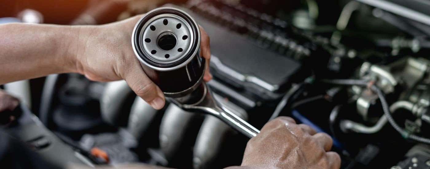 Tech changing an oil filter at a Honda service center near Grapevine