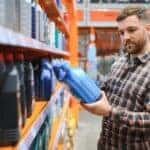 A person observing an oil container.