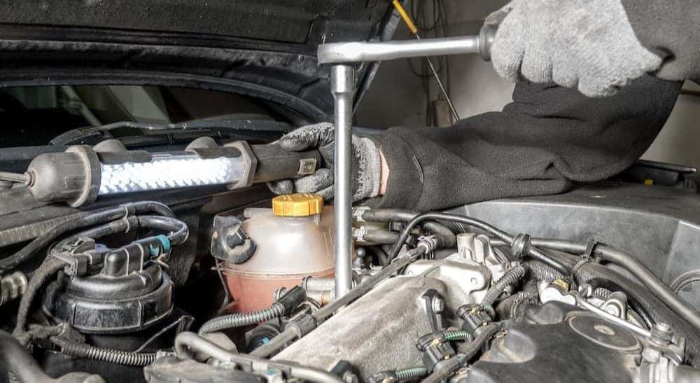 A technician changing spark plugs.
