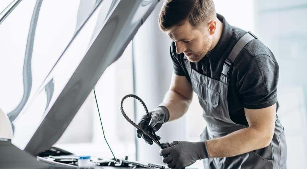 A technician changing a timing belt.