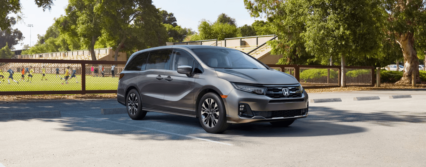 Silver 2026 Honda Odyssey parked at a ball field