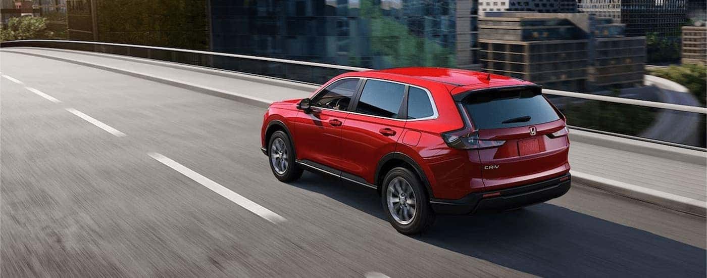 Red 2026 Honda CR-V driving on a highway