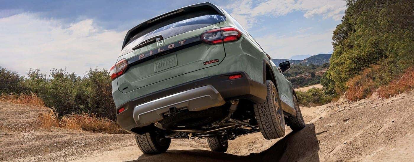 Green 2026 Honda Pilot TrailSport driving off-road