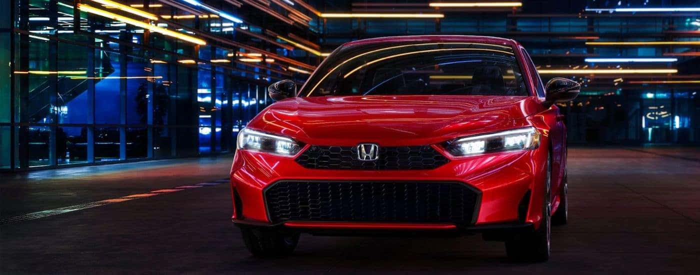 Red 2026 Honda Civic front view at night.