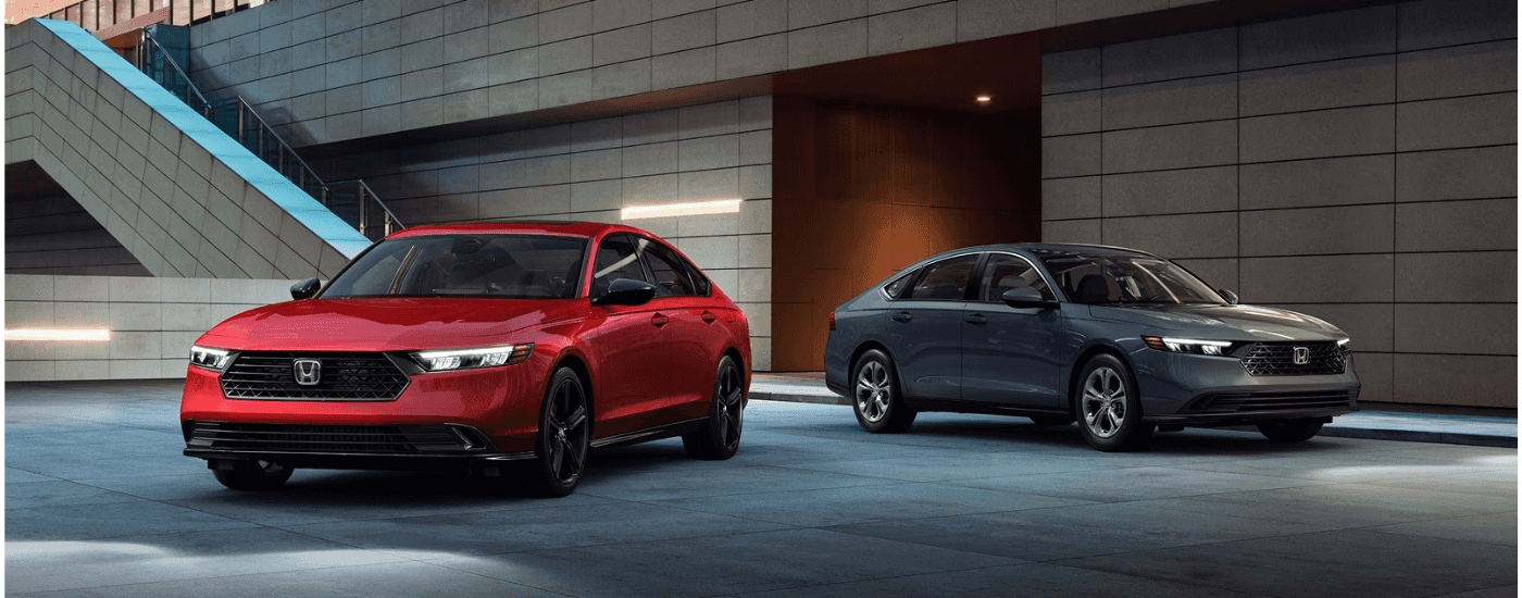 A red and a gray 2026 Honda Accord parked side-by-side.
