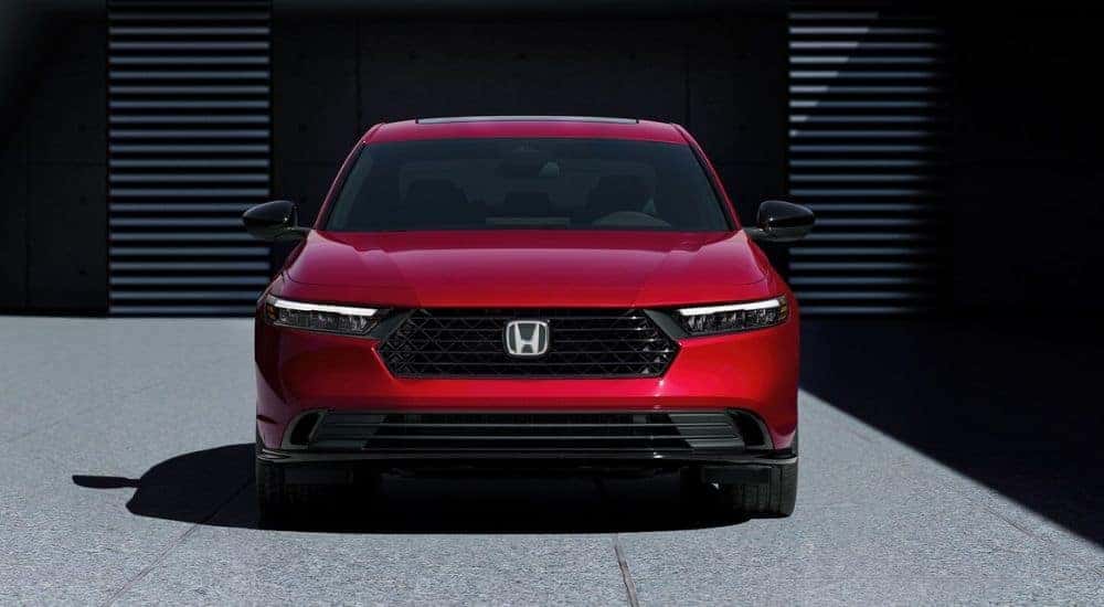 A red 2026 Honda Accord Sport-L Hybrid parked head-on.