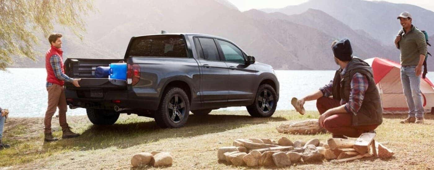 A gray 2026 Honda Ridgeline parked near a lake.