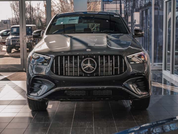 Front view of a silver 2026 Mercedes-AMG GLE 53 SUV in the show room of new car dealership, Ray Catena of Freehold, New Jersey
