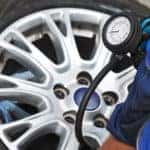 close up of man checking tire pressure