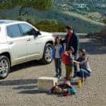 Family standing by Chevy Traverse