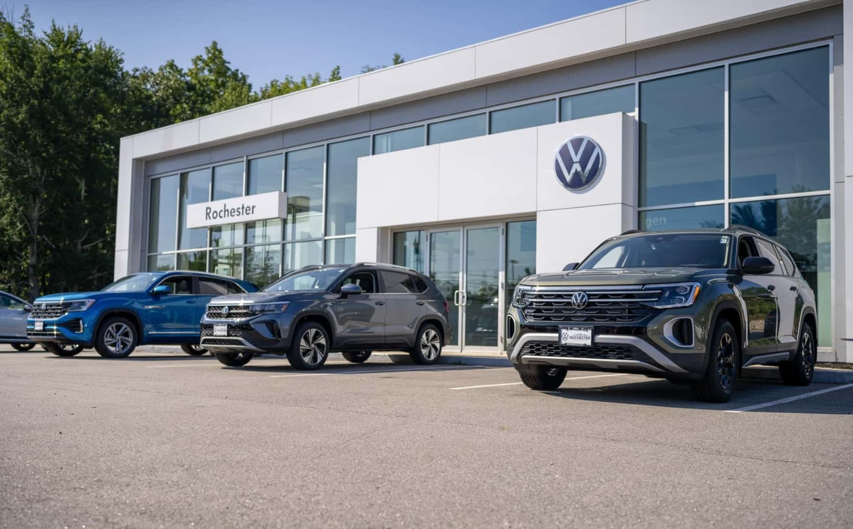 Front door of dealership with part of the parking lot