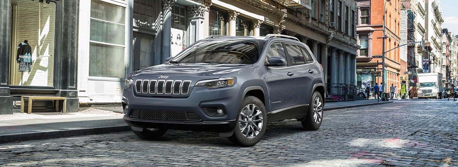 2019 Jeep Cherokee Trailhawk vs. Overland vs. Trailhawk Elite A silver 2019 Jeep Cherokee parked on a stone street