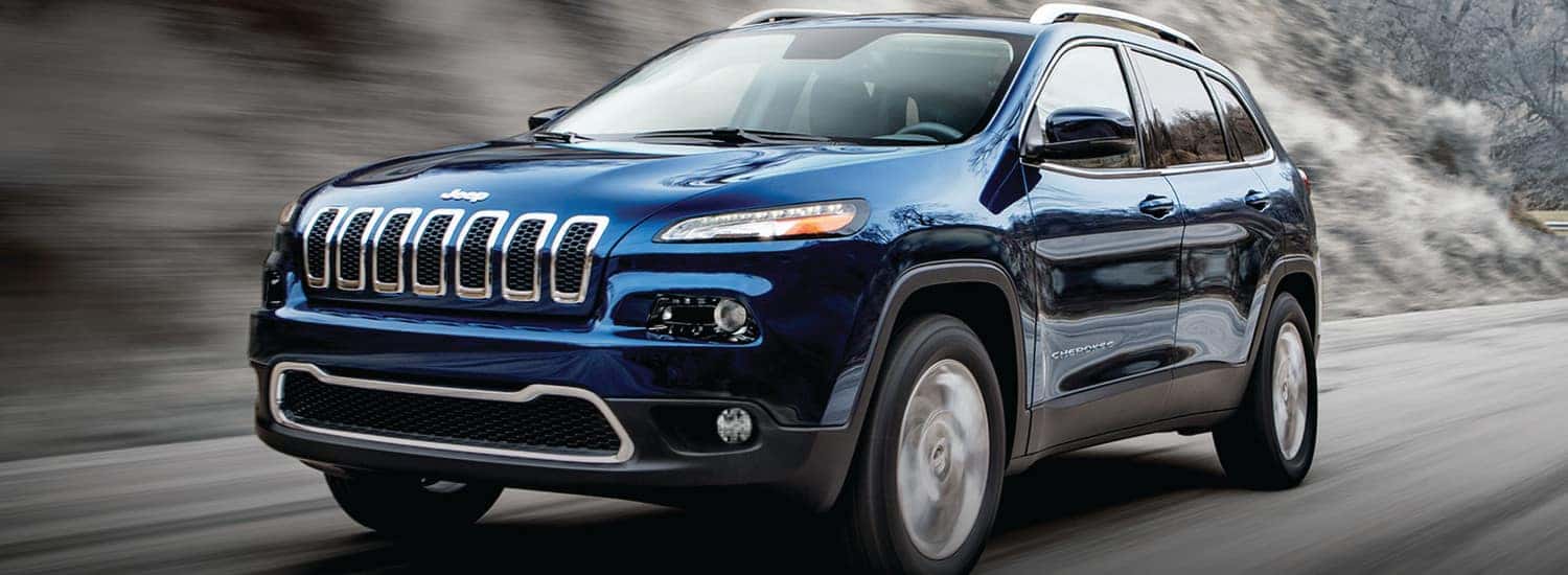 2019 Jeep Cherokee Latitude vs Latitude Plus vs. Limited A blue 2019 Jeep Cherokee driving nature