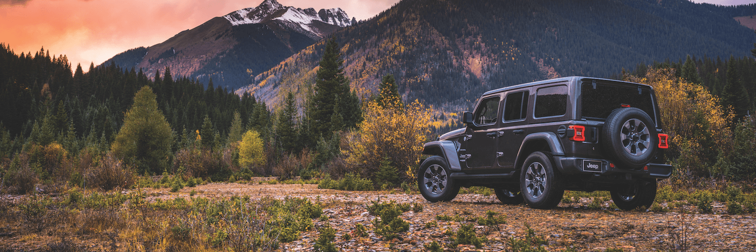 Jeep Wrangler A Jeep Wrangler parked in front of the mountains