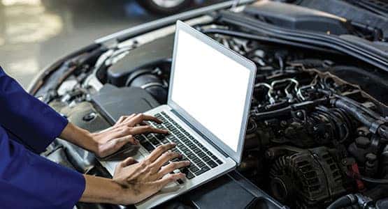 A service worker typing on a laptop