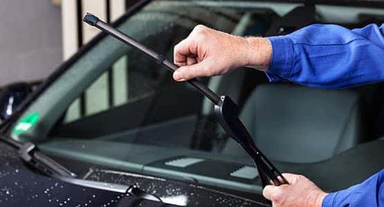 A service worker changing wiper blades