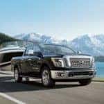 2018 Nissan Titan Towing Boat in front of Mountains and Lake