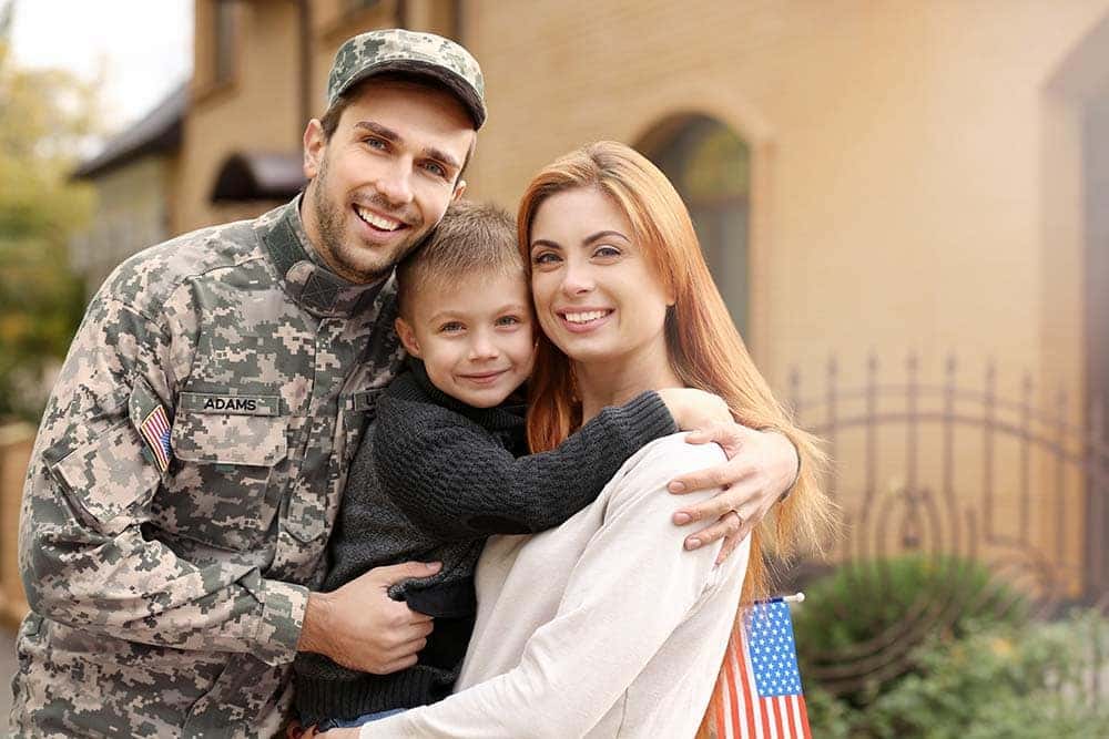 Soldier reunited with his family on a sunny day