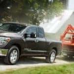 Black Nissan Titan towing construction vehicle. Nissan Titan towing capacity concept.