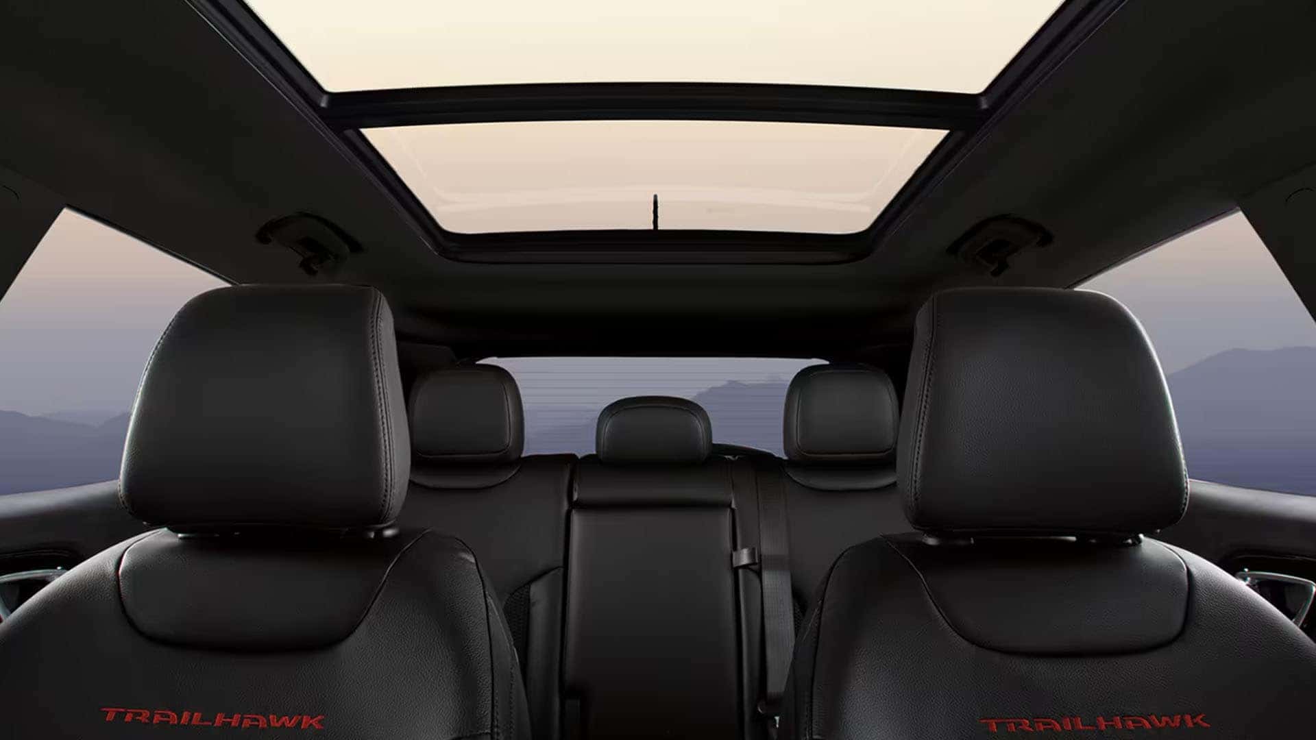 2025 Jeep Compass interior with panoramic sunroof and black leather seats