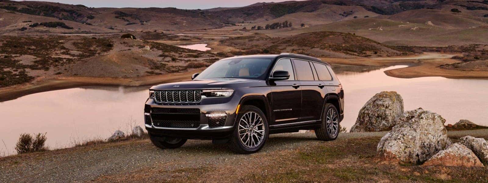 2025 Jeep Grand Cherokee exterior parked on a scenic road