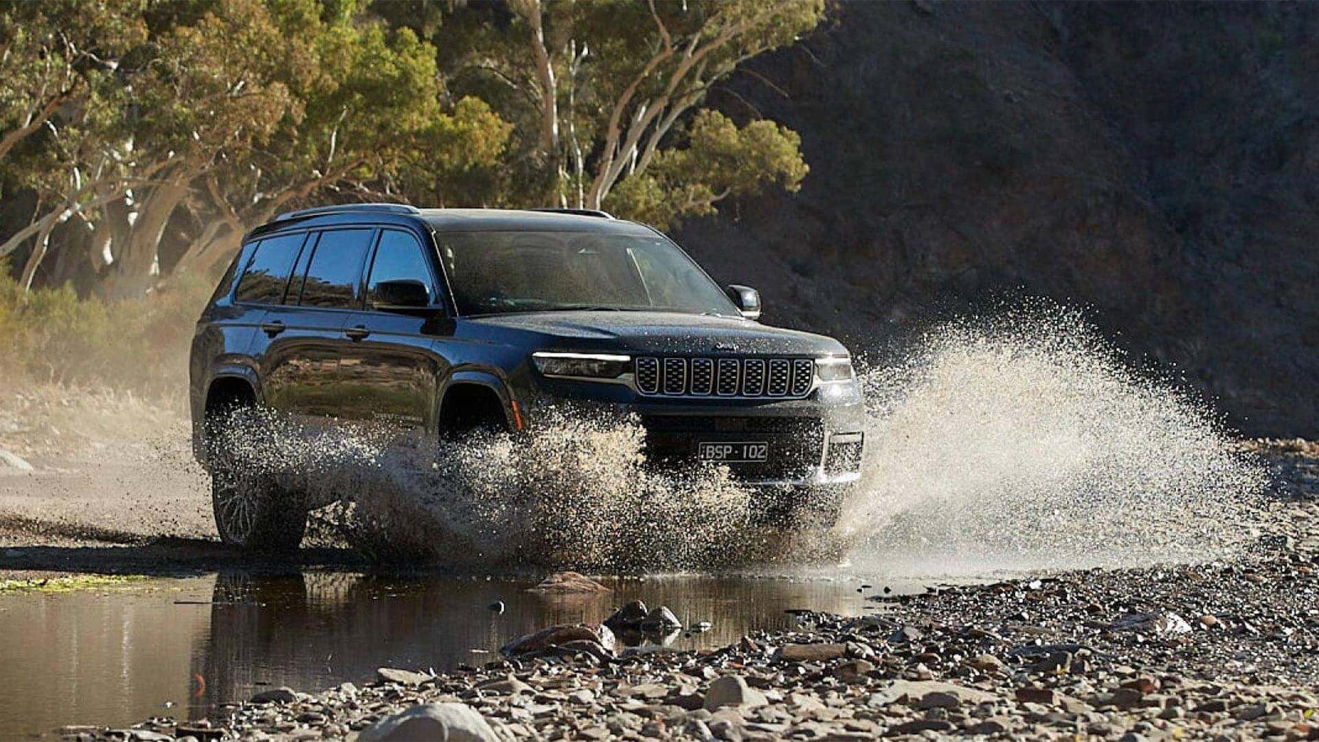 2026 Jeep Grand Cherokee on a trail showing ground clearance and underbody protection