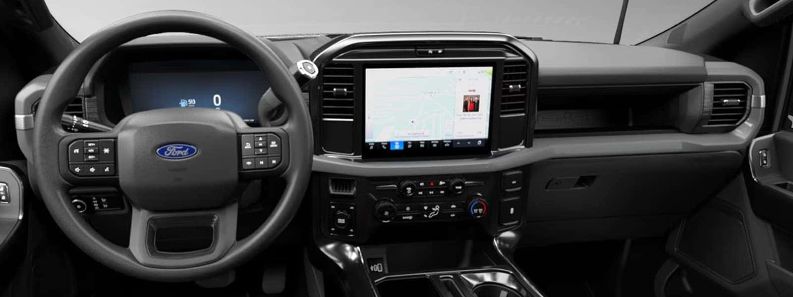 Interior view of the 2026 Ford F-150 showing the steering wheel, digital driver display, and large center touchscreen with SYNC 4 infotainment