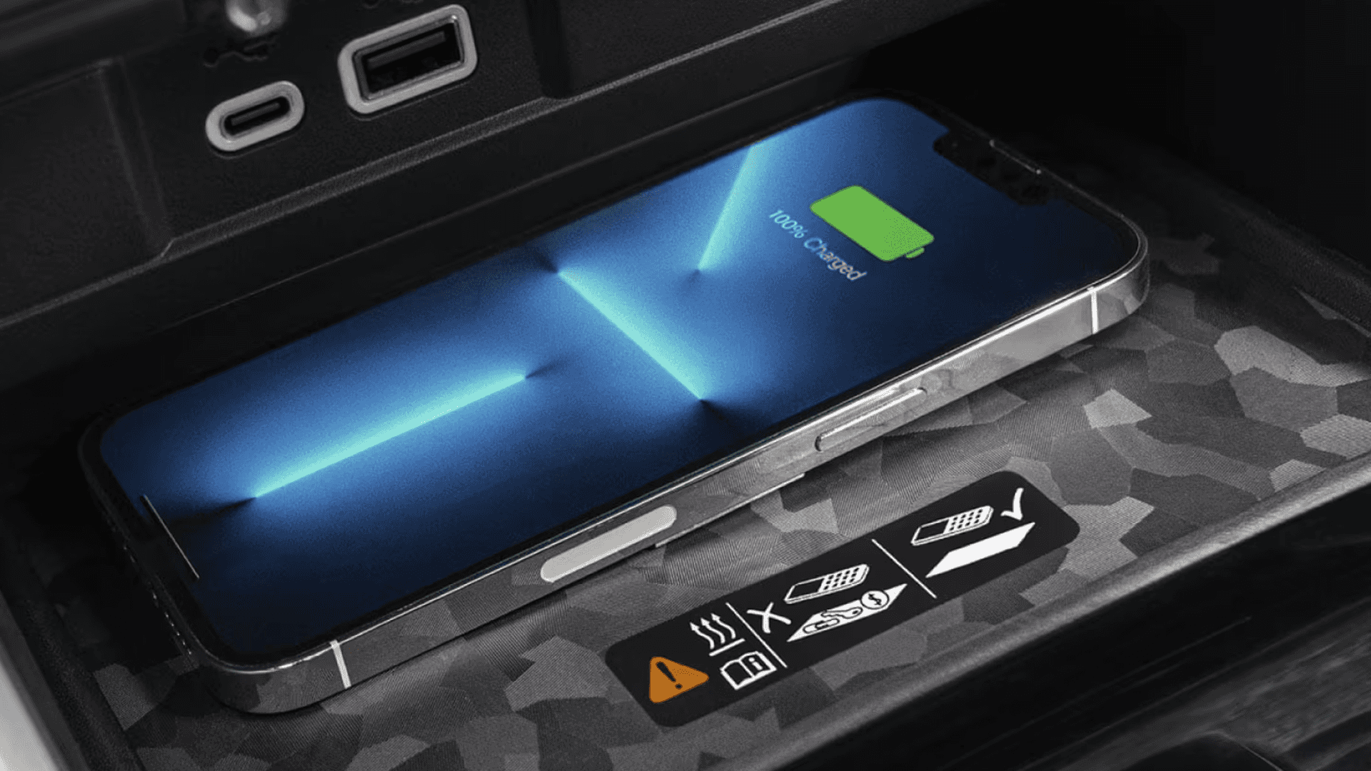 Smartphone charging wirelessly on a charging pad inside a Chevy Colorado center console