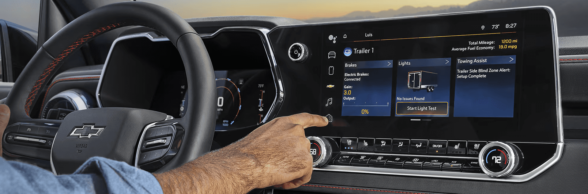 Driver using the Chevy Colorado infotainment screen to adjust trailer brake and towing assist settings