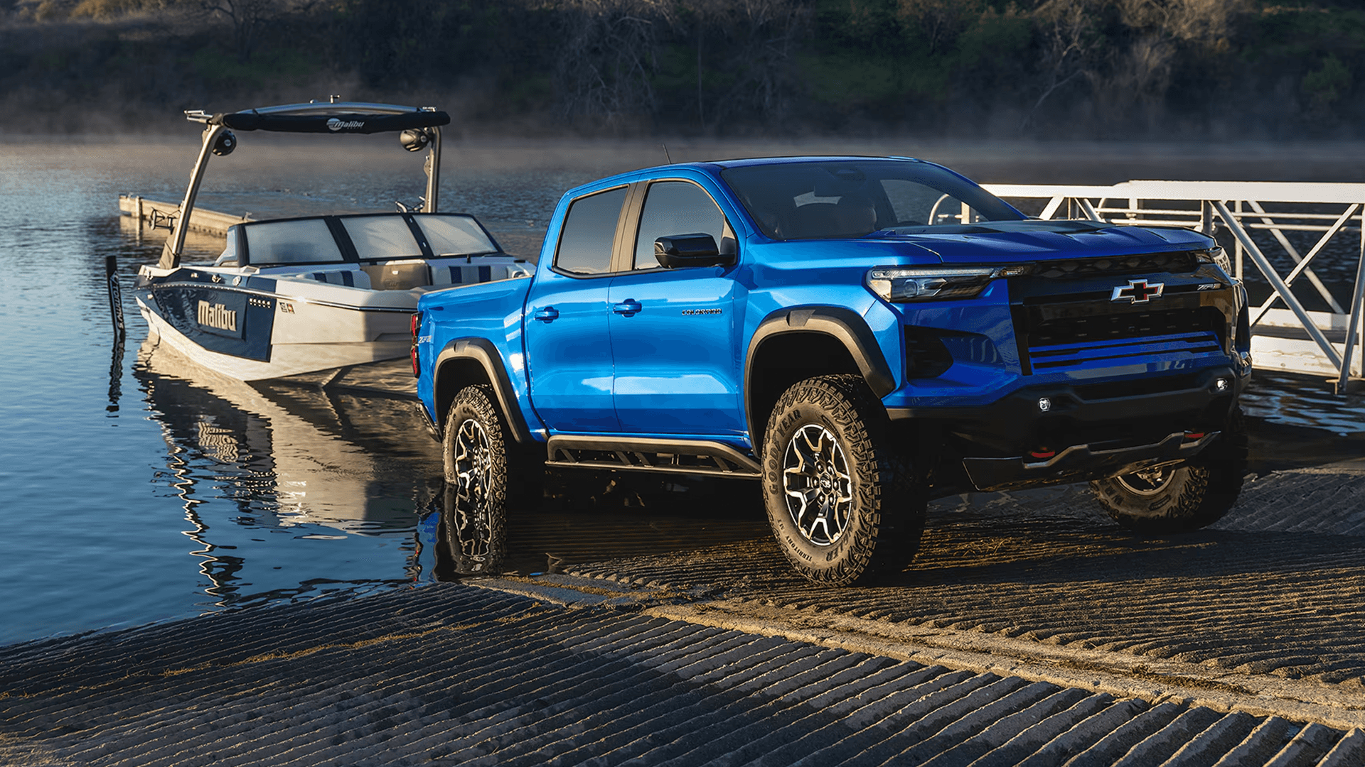Chevy Colorado ZR2 towing a wake boat at a lake boat ramp