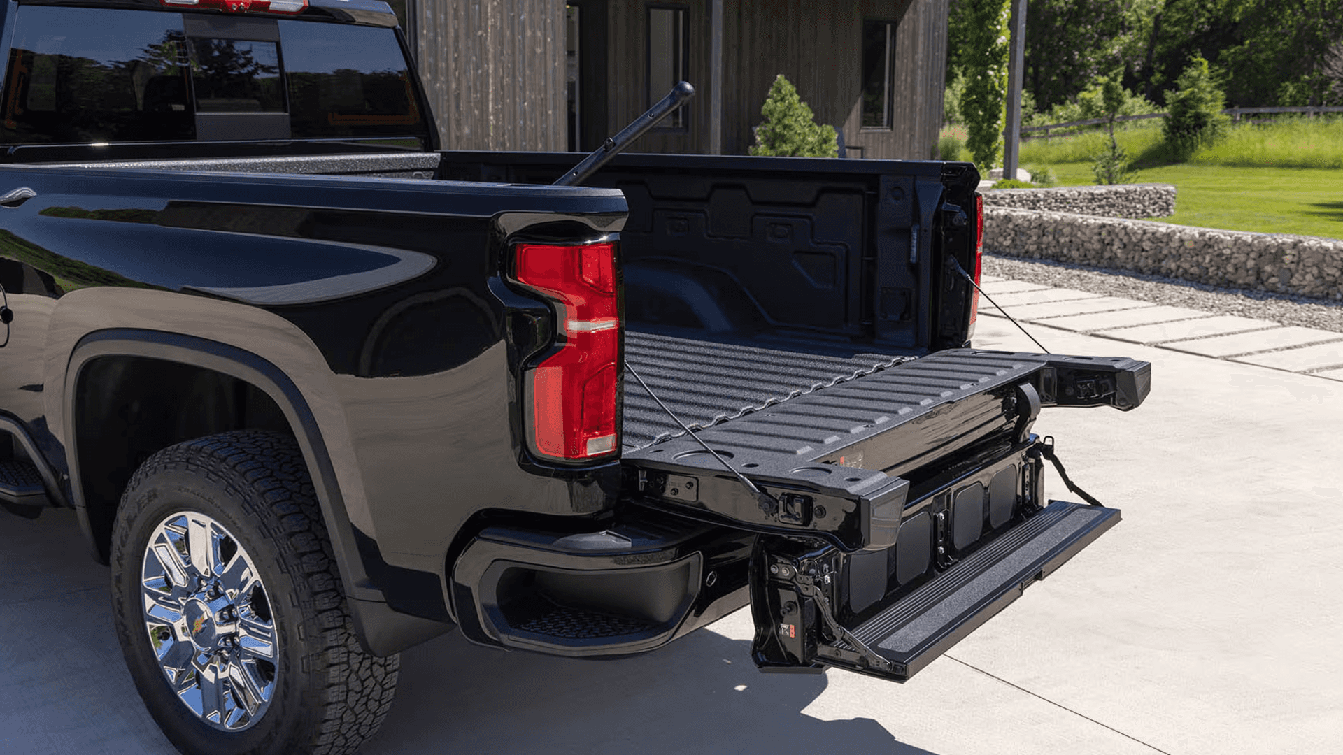 2026 Chevy Silverado HD cargo bed with Multi Flex Tailgate step system deployed, showing inner gate and full width step for easier access