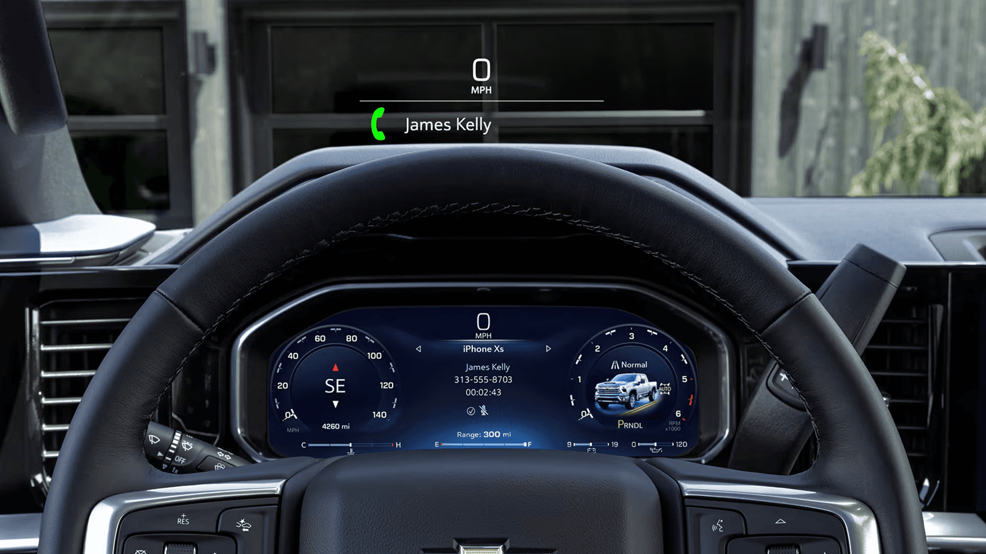 2026 Chevy Silverado HD steering wheel and digital instrument cluster with a head up display projection showing speed and call information above the wheel