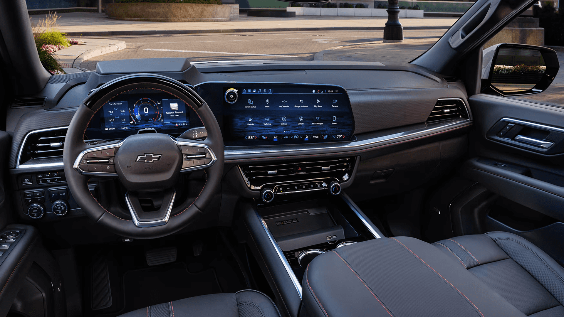 interior view of a 2026 Chevrolet Tahoe showing steering wheel, digital instrument cluster, and wide touchscreen infotainment display