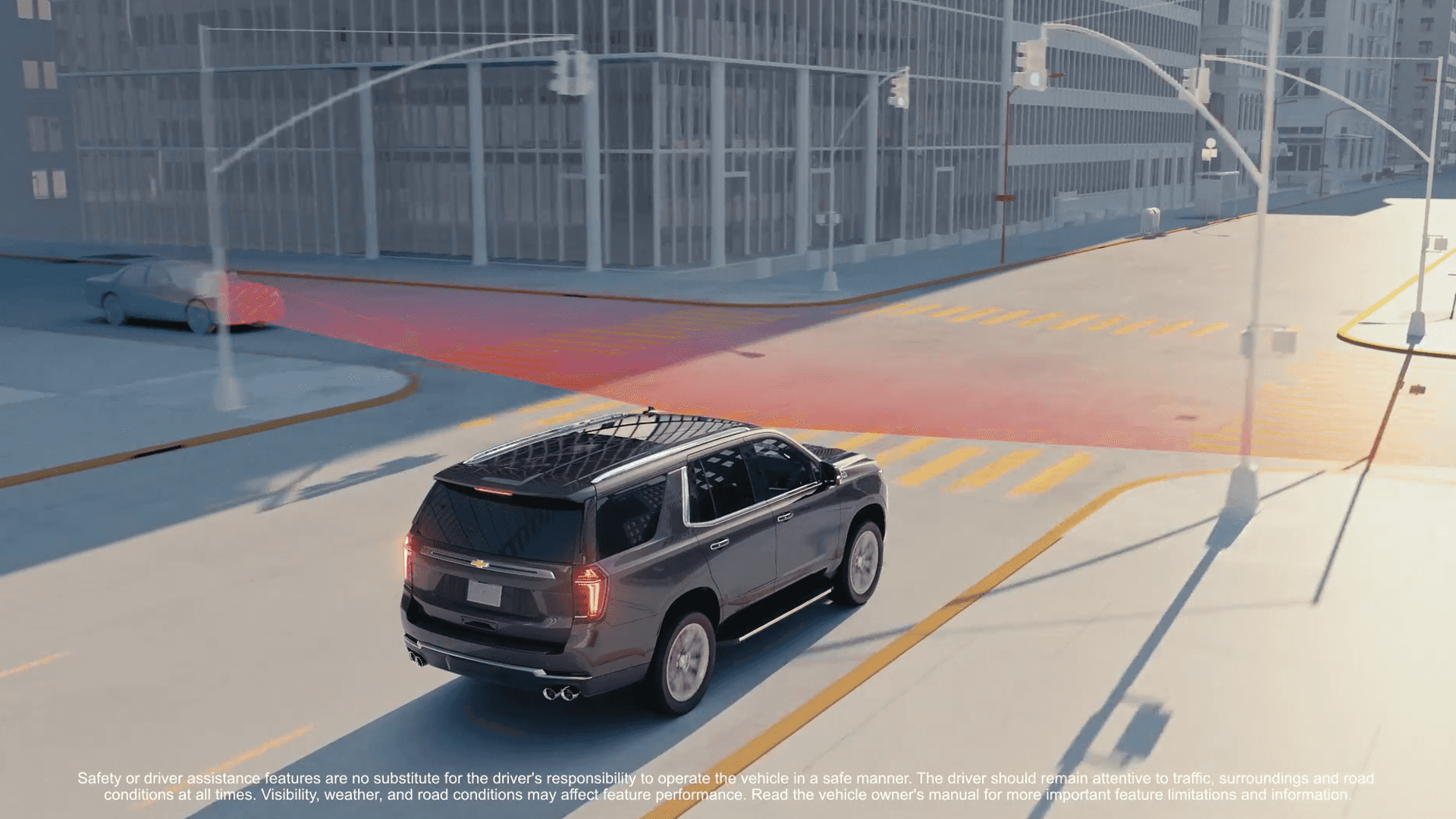 2026 Chevrolet Tahoe front three quarter view driving on a road with safety icons overlay showing lane keep assist, forward collision alert, and adaptive cruise control