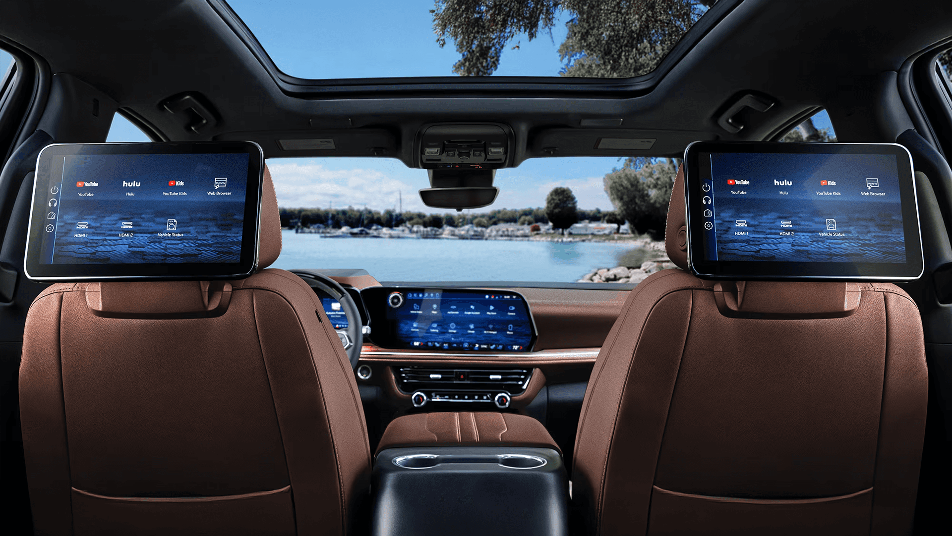 Rear seat entertainment system in the 2026 Chevy Tahoe with dual headrest mounted screens and panoramic sunroof