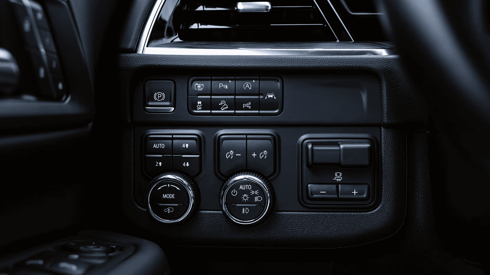 Driver side control panel in the 2026 Chevy Tahoe with parking brake, drive mode selector, lighting controls, and trailer brake controller