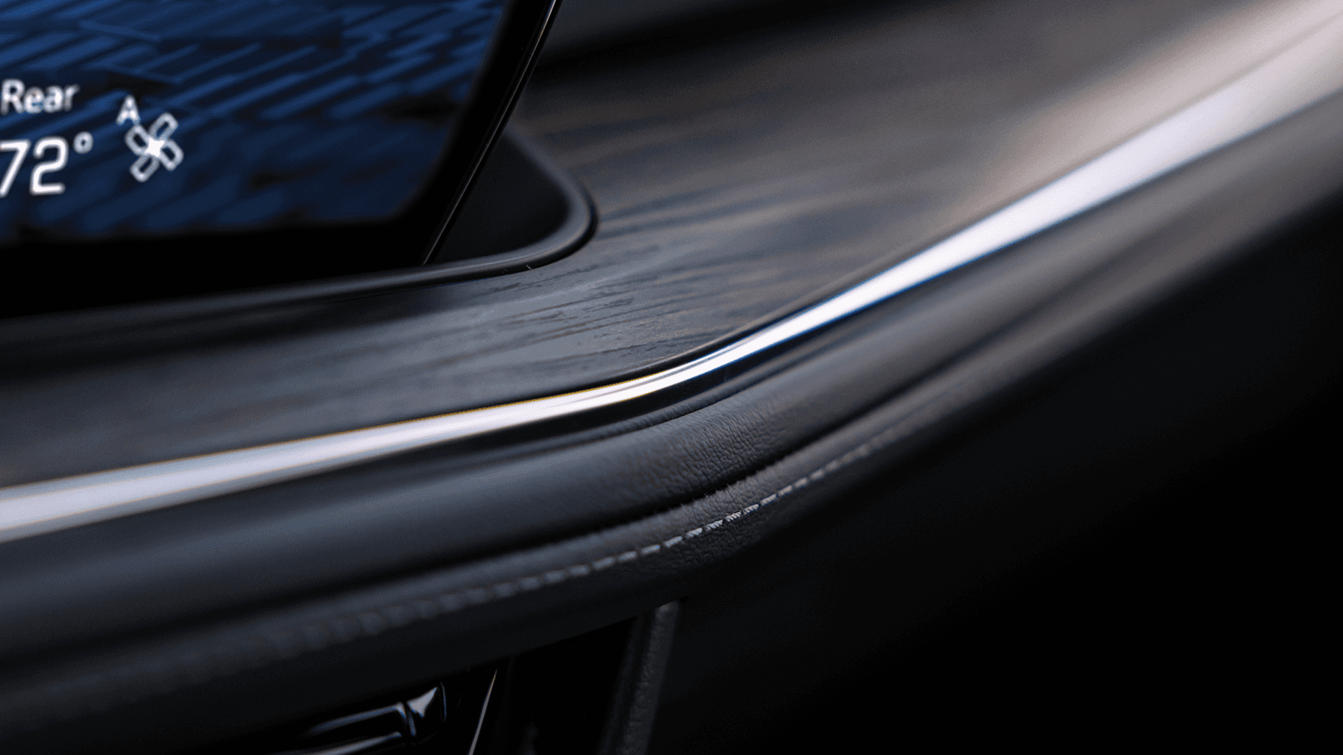 Interior dashboard detail in the 2026 Chevy Tahoe showing wood trim and ambient accent lighting
