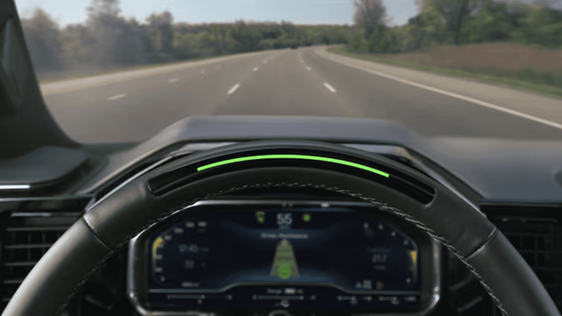 Driver view from the 2026 Chevy Tahoe showing Super Cruise hands free driving indicator on the steering wheel while traveling on a highway