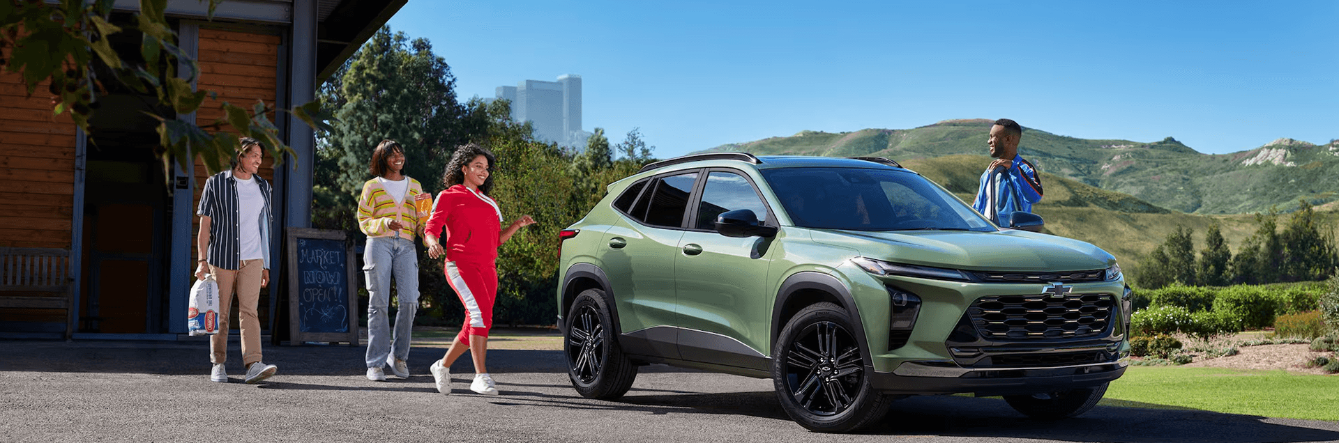 2026 Chevy Trax compact SUV parked near a neighborhood park