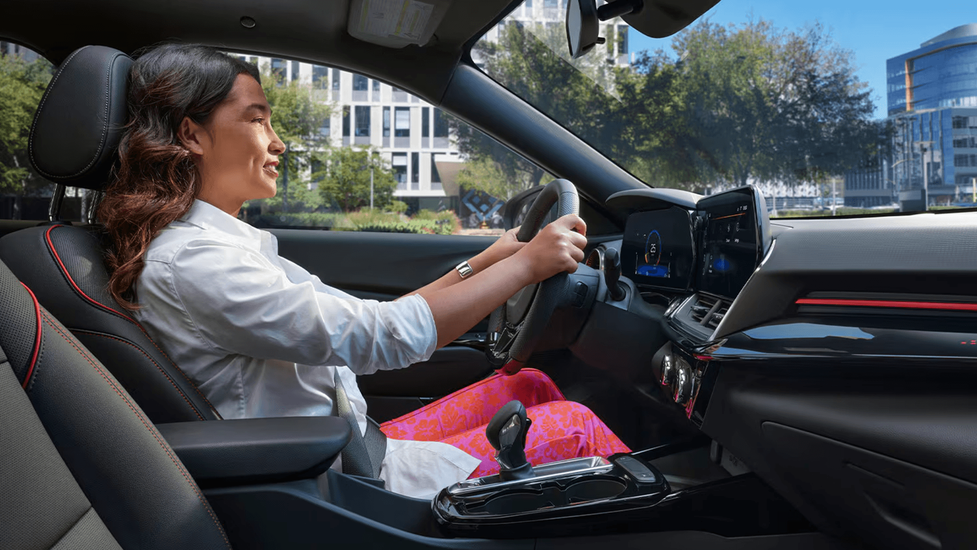 2026 Chevy Trax interior with driver in city setting