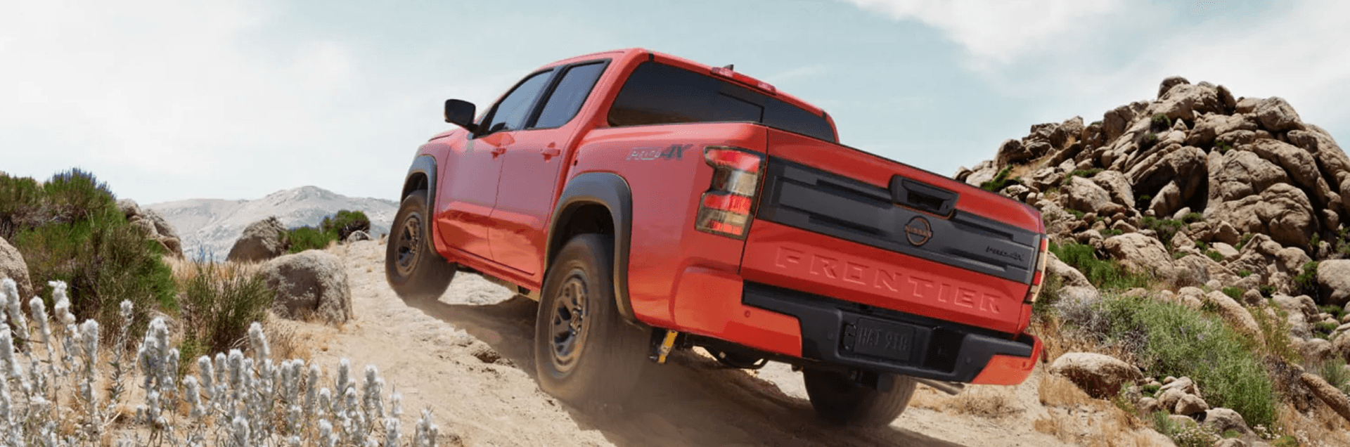 2026 Nissan Frontier driving off road in a desert landscape