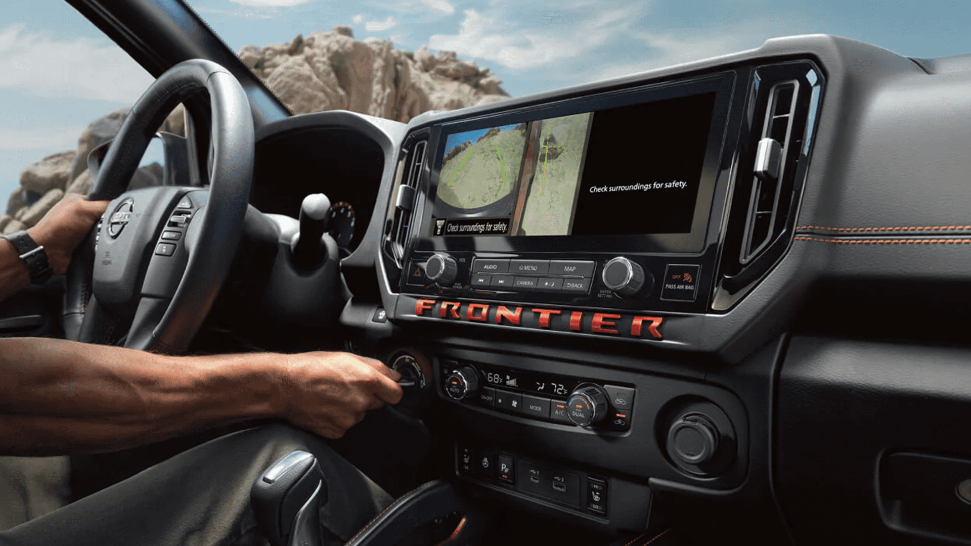 2026 Nissan Frontier dashboard with large touchscreen showing camera view, steering wheel controls, and connected truck technology