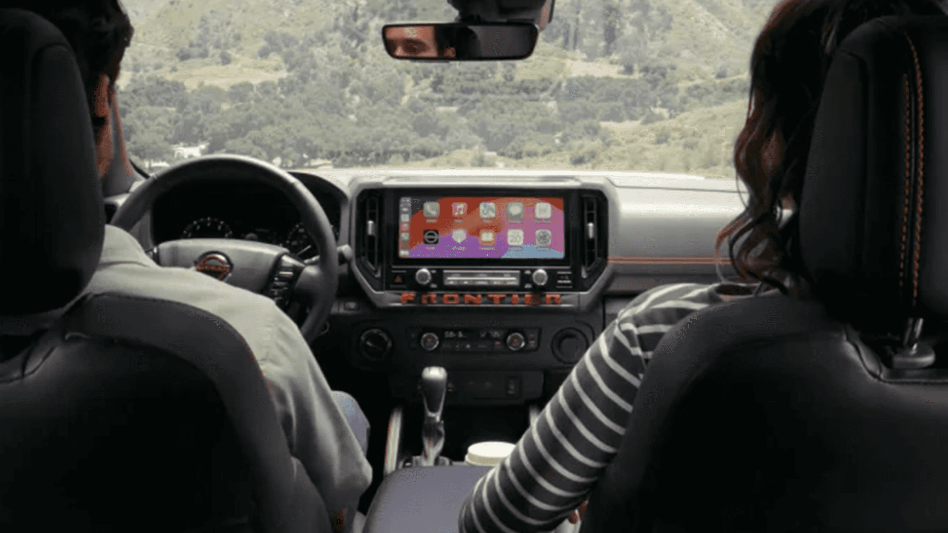 View from the back seat showing the center touchscreen and dashboard controls up front